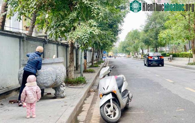 Một người dân hóa vàng mã dịp Tết ông Táo tại một khu đô thị ở quận Bắc Từ Liêm.
