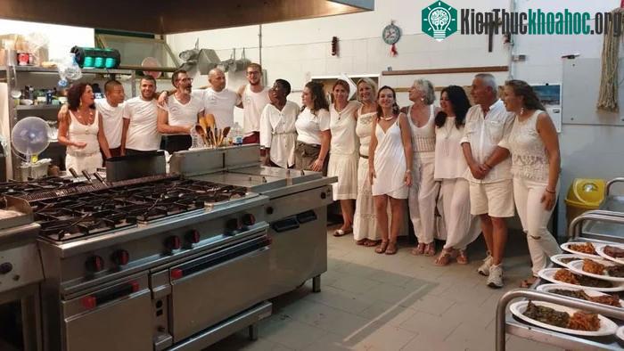 Du khách chụp ảnh với các nam tù nhân làm nhân viên khách sạn ở Pianosa.