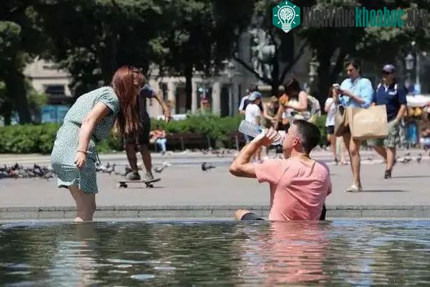 Mọi người đang tìm nơi có bóng cây và nước để tránh cái nóng mùa hè.