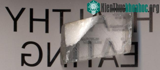 Ánh sáng đi qua tinh thể canxít tạo ra hai ảnh của chữ viết nằm bên dưới, tương ứng với tia thường và tia khác thường.