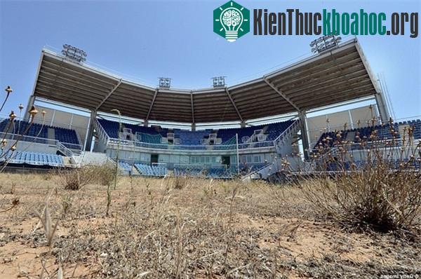 Chỗ ngồi bị hoen ố bởi ánh nắng mặt trời, cỏ dại mọc chằng chịt quanh sân.