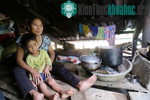 Bà Cao Thị Xuyên kê mấy thanh gỗ sát mái nhà để tránh lũ. Bữa cơm giữa lũ ăn với muối trắng. (Ảnh: Hoàng Táo).