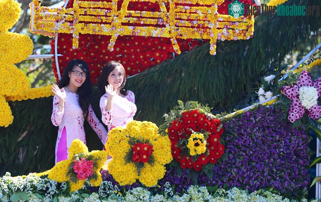 Các thiếu nữ vẫy chào khách trên xe hoa diễu hành.