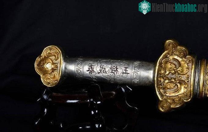 Tay cầm thanh kiếm với 4 chữ "Vương quyền Thành Thái".