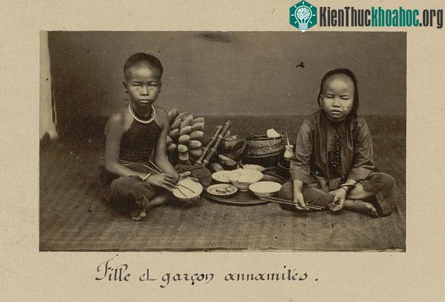 Một bé gái (trái) và bé trai (phải) bên mâm cơm